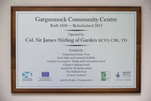 Plaque commemorating the opening of the upgarde Community Centre after teh Community Trust took ownership of it from Stirling Council